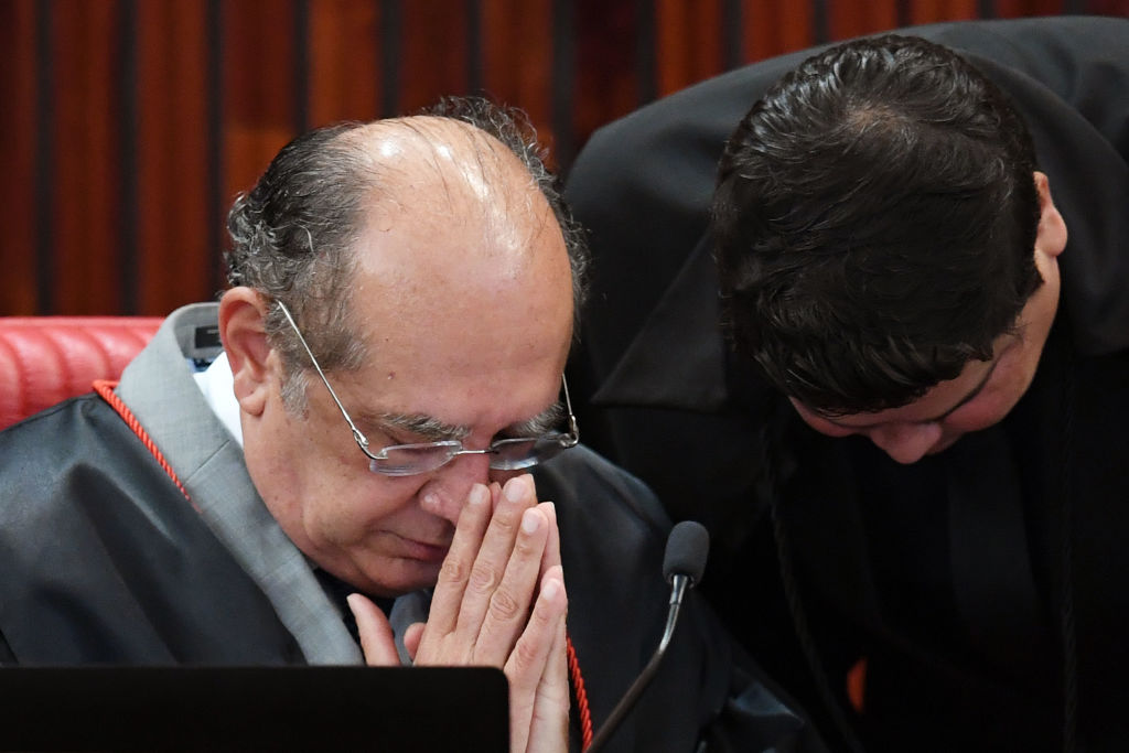 Supreme Electoral Court (TSE) President Judge Gilmar Mendes (L), gestures during a session examining whether the 2014 reelection of president Dilma Rousseff and her then-vice president Temer should be invalidated because of corrupt campaign funding, in Brasilia, on June 7, 2017.<br /><br />
Judges on Brazil's electoral court were expected to start voting Wednesday in a case that could topple scandal-tainted President Michel Temer. If the court votes to scrap the election result, Temer -- who took over only last year when Rousseff was impeached -- would himself risk losing his office.<br /><br />
 / AFP PHOTO / EVARISTO SA        (Photo credit should read EVARISTO SA/AFP/Getty Images)